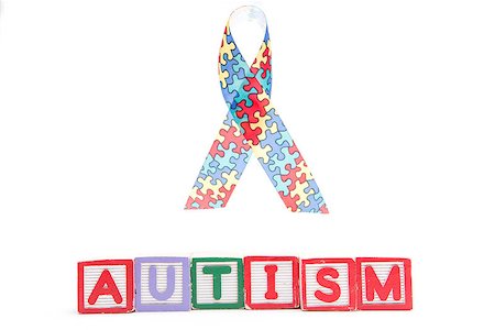 Autism awareness ribbon above letter blocks spelling autism on white background Stockbilder - Microstock & Abonnement, Bildnummer: 400-06876346