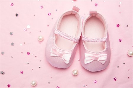 Baby shoes for a girl on pink blanket with pearls Stock Photo - Budget Royalty-Free & Subscription, Code: 400-06876445