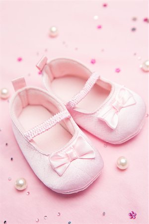 Pink baby shoes for a girl on pink blanket with pearls Stock Photo - Budget Royalty-Free & Subscription, Code: 400-06876446