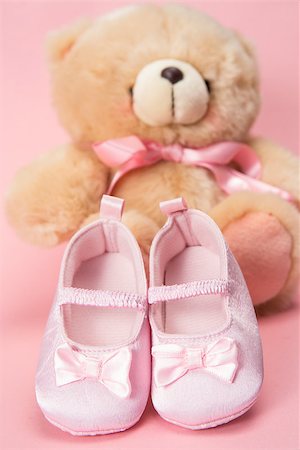 Pink baby booties and teddy bear on pink background Stock Photo - Budget Royalty-Free & Subscription, Code: 400-06876463