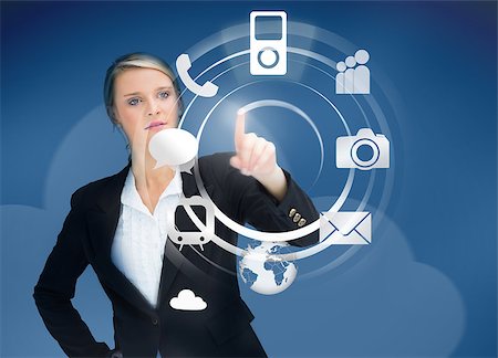 Businesswoman using wheel application interface on blue background Stock Photo - Budget Royalty-Free & Subscription, Code: 400-06876583