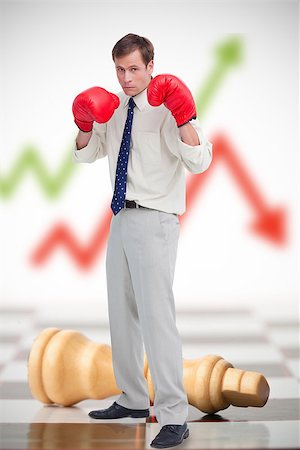 simsearch:400-06876600,k - Businessman in boxing gloves on chessboard with red and green arrow in background Stock Photo - Budget Royalty-Free & Subscription, Code: 400-06876599