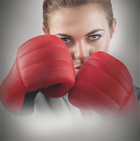 simsearch:400-06876600,k - Powerful female boxer with fists up and red boxing gloves Stock Photo - Budget Royalty-Free & Subscription, Code: 400-06876604