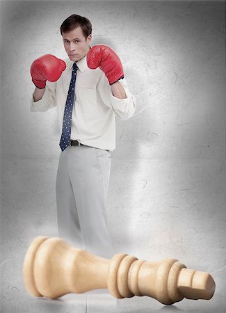 simsearch:400-06876600,k - Businessman in red boxing gloves with knocked over white chess piece Stock Photo - Budget Royalty-Free & Subscription, Code: 400-06876602