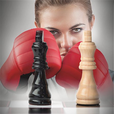 simsearch:400-06876600,k - Female boxer with fists raised behind the chess board Stock Photo - Budget Royalty-Free & Subscription, Code: 400-06876603