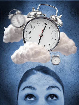 simsearch:400-06876570,k - Woman looking up at alarm clock in clouds against blue background Foto de stock - Royalty-Free Super Valor e Assinatura, Número: 400-06876681