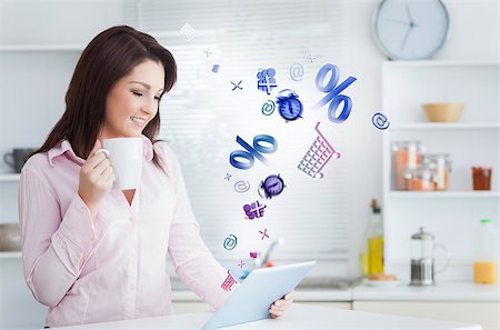 Woman using applications from tablet at home in the kitchen drinking coffee Stock Photo - Budget Royalty-Free & Subscription, Code: 400-06876727