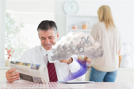 Businessman reading paper while tablet is connecting to cloud computing at home in the kitchen Stock Photo - Budget Royalty-Free & Subscription, Code: 400-06876732