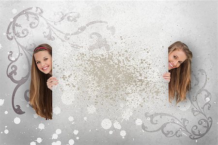 simsearch:400-06876753,k - Pretty girls peeking out from behind copy space on grey art deco style background Photographie de stock - Aubaine LD & Abonnement, Code: 400-06876760
