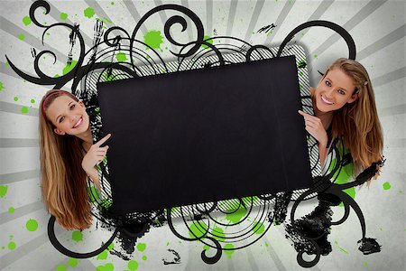 simsearch:400-06876781,k - Girls pointing to black copy space with artistic black swirls and green paint splashes Foto de stock - Royalty-Free Super Valor e Assinatura, Número: 400-06876774