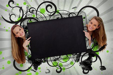 simsearch:400-06876787,k - Girls pointing to black copy space with artistic black swirls and green paint splashes Foto de stock - Super Valor sin royalties y Suscripción, Código: 400-06876774