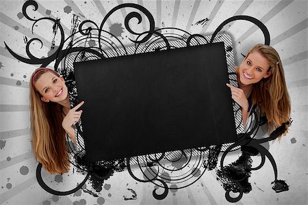 simsearch:400-06876781,k - Girls pointing to black copy space with artistic swirl frame and grey paint splashes Foto de stock - Royalty-Free Super Valor e Assinatura, Número: 400-06876775