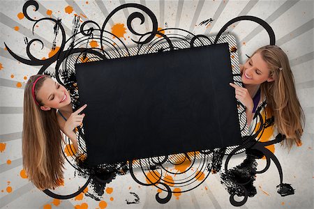 simsearch:400-06876781,k - Girls pointing to black copy space on artistic swirl design background Foto de stock - Royalty-Free Super Valor e Assinatura, Número: 400-06876773