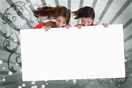 simsearch:400-06876753,k - Pretty girls looking down at white copy space screen on grey art deco style background Photographie de stock - Aubaine LD & Abonnement, Code: 400-06876781