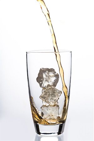 simsearch:400-06877048,k - Liquid pouring into glass with ice cubes on white background Foto de stock - Royalty-Free Super Valor e Assinatura, Número: 400-06876821