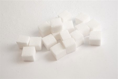 sugar cube on white - Pile of sugar lumps against a white background Stock Photo - Budget Royalty-Free & Subscription, Code: 400-06876861