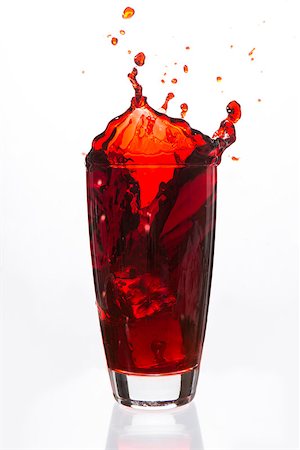 simsearch:400-06877048,k - Ices cubes falling in a glass of red liquid on white background Foto de stock - Royalty-Free Super Valor e Assinatura, Número: 400-06877049