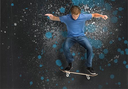 spritzlack - Cool young skateboarder doing an ollie trick on blue and grey paint splattered background Stockbilder - Microstock & Abonnement, Bildnummer: 400-06877082