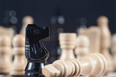 simsearch:400-06876600,k - Fallen white chess piece lying next to black knight on chess board Stock Photo - Budget Royalty-Free & Subscription, Code: 400-06877107