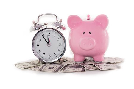 Piggy bank beside alarm clock on dollars on white backgroun Stock Photo - Budget Royalty-Free & Subscription, Code: 400-06877109