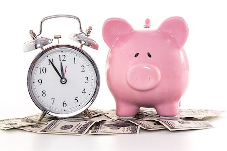 simsearch:400-06876570,k - Pink piggy bank beside alarm clock on dollars on white background Photographie de stock - Aubaine LD & Abonnement, Code: 400-06877110