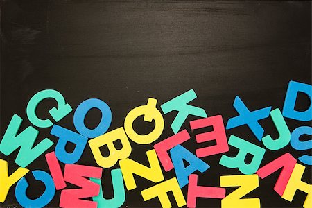 Alphabet magnets in a jumble on bottom of blackboard with copy space Fotografie stock - Microstock e Abbonamento, Codice: 400-06877239