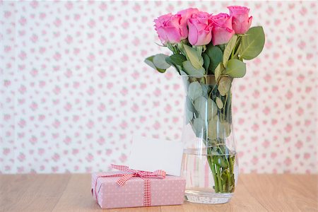 simsearch:400-06877945,k - Bunch of pink roses in vase with pink gift and blank card on wooden table Stock Photo - Budget Royalty-Free & Subscription, Code: 400-06877346