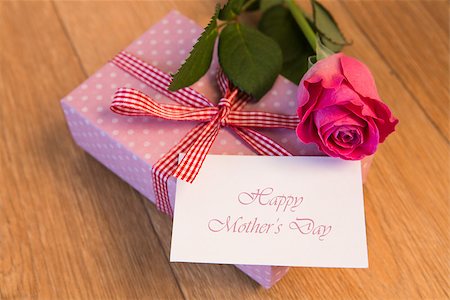 Pink wrapped present with happy mothers day card and pink rose on wooden table Stock Photo - Budget Royalty-Free & Subscription, Code: 400-06877355