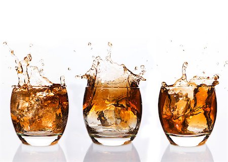 Serial arrangement of whiskey splashing in tumbler on white background Stock Photo - Budget Royalty-Free & Subscription, Code: 400-06877586