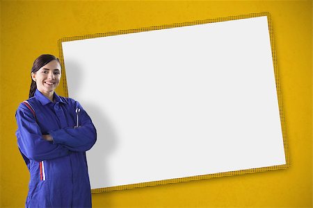 Smiling female mechanic standing in front of a blank screen Stockbilder - Microstock & Abonnement, Bildnummer: 400-06877611