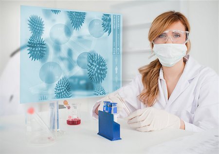 Scientist working in the lab with futuristic interface showing virus Stock Photo - Budget Royalty-Free & Subscription, Code: 400-06877728