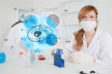 Scientist with protective mask using cell diagram interface in the lab Stock Photo - Budget Royalty-Free & Subscription, Code: 400-06877739