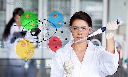 Serious chemist working with colourful cell diagram inteface in the lab Stock Photo - Budget Royalty-Free & Subscription, Code: 400-06877748