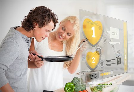 simsearch:400-06891385,k - Couple preparing dinner using futuristic interface in the kitchen Stock Photo - Budget Royalty-Free & Subscription, Code: 400-06877757