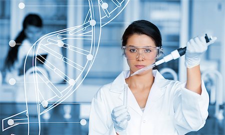 Serious chemist working with white dna helix diagram inteface in the lab Stock Photo - Budget Royalty-Free & Subscription, Code: 400-06877750