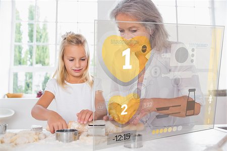 Grandmother and granddaughter baking with holographic interface Stock Photo - Budget Royalty-Free & Subscription, Code: 400-06877760