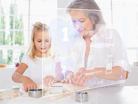 Grandmother and granddaughter baking with white holographic interface Stock Photo - Budget Royalty-Free & Subscription, Code: 400-06877761