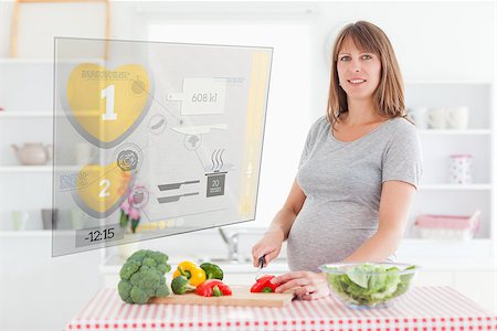simsearch:400-06891385,k - Pregnant woman making dinner using hologram interface in the kitchen Stock Photo - Budget Royalty-Free & Subscription, Code: 400-06877770