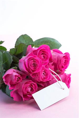 simsearch:400-06877837,k - Bouquet of pink roses with an empty card on a light pink table Stock Photo - Budget Royalty-Free & Subscription, Code: 400-06877838