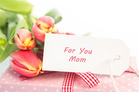 simsearch:400-06877945,k - Bouquet of tulips next to a gift with a card for a mother close up Stock Photo - Budget Royalty-Free & Subscription, Code: 400-06877849