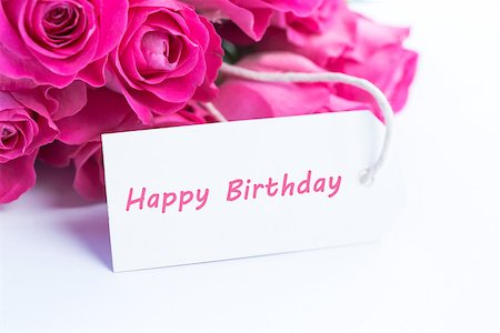 Close up of a beautiful bouquet of pink roses with a happy birthday card on a white table Stock Photo - Budget Royalty-Free & Subscription, Code: 400-06877842