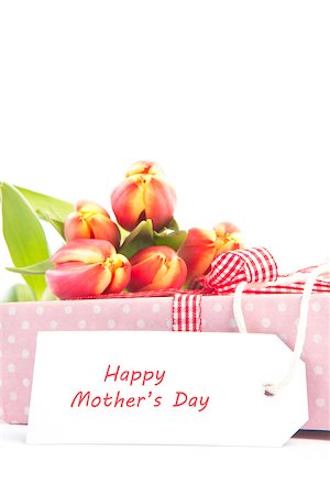 simsearch:400-06877945,k - Bouquet of beautiful tulips on a gift with a happy mothers card on a white table Stock Photo - Budget Royalty-Free & Subscription, Code: 400-06877854