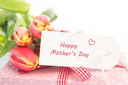simsearch:400-06877837,k - Bouquet of beautiful tulips next to a gift with a happy mothers day card Stock Photo - Budget Royalty-Free & Subscription, Code: 400-06877850