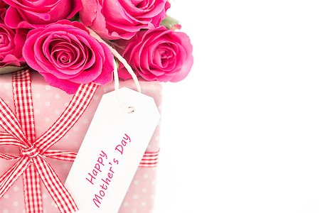 simsearch:400-06877837,k - Close up of a bouquet of pink roses next to a pink gift with a happy mothers day card on a white background close up Stock Photo - Budget Royalty-Free & Subscription, Code: 400-06877942