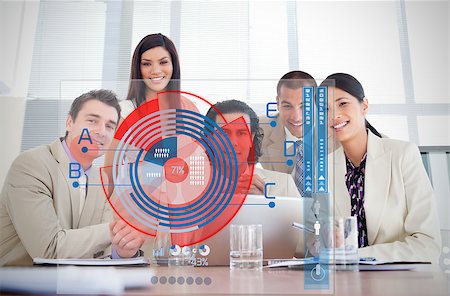 Smiling business workers looking at chart interface in a meeting Stock Photo - Budget Royalty-Free & Subscription, Code: 400-06878249