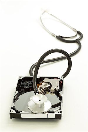 Disk drive with stethoscope resting on it on white background Photographie de stock - Aubaine LD & Abonnement, Code: 400-06878351