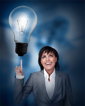 simsearch:400-06878460,k - Businesswoman looking up at the big light bulb above her finger Stock Photo - Budget Royalty-Free & Subscription, Code: 400-06878486