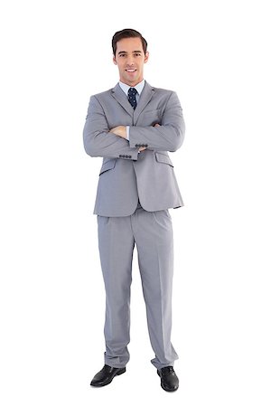 simsearch:400-07274414,k - Smiling businessman standing with his arms crossed on white background Photographie de stock - Aubaine LD & Abonnement, Code: 400-06878927