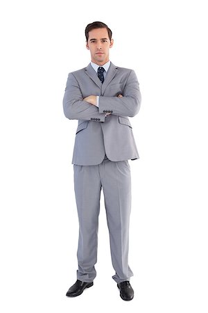 simsearch:400-07274414,k - Serious businessman standing with his arms crossed on white background Photographie de stock - Aubaine LD & Abonnement, Code: 400-06878928