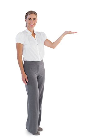 simsearch:400-06883455,k - Smiling businesswoman presenting something with her hand on white background Photographie de stock - Aubaine LD & Abonnement, Code: 400-06878966